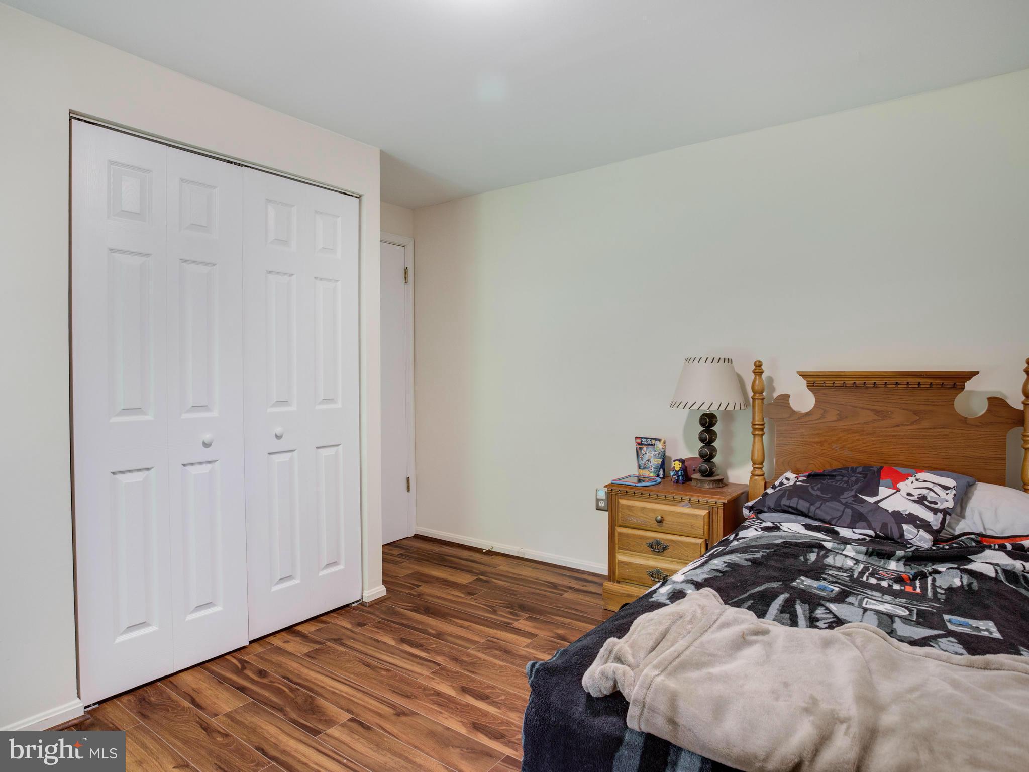 12708 Olivet Road Lusby, MD 20657 - Photo 11 of 22 a view of a bedroom with bed and wooden floor