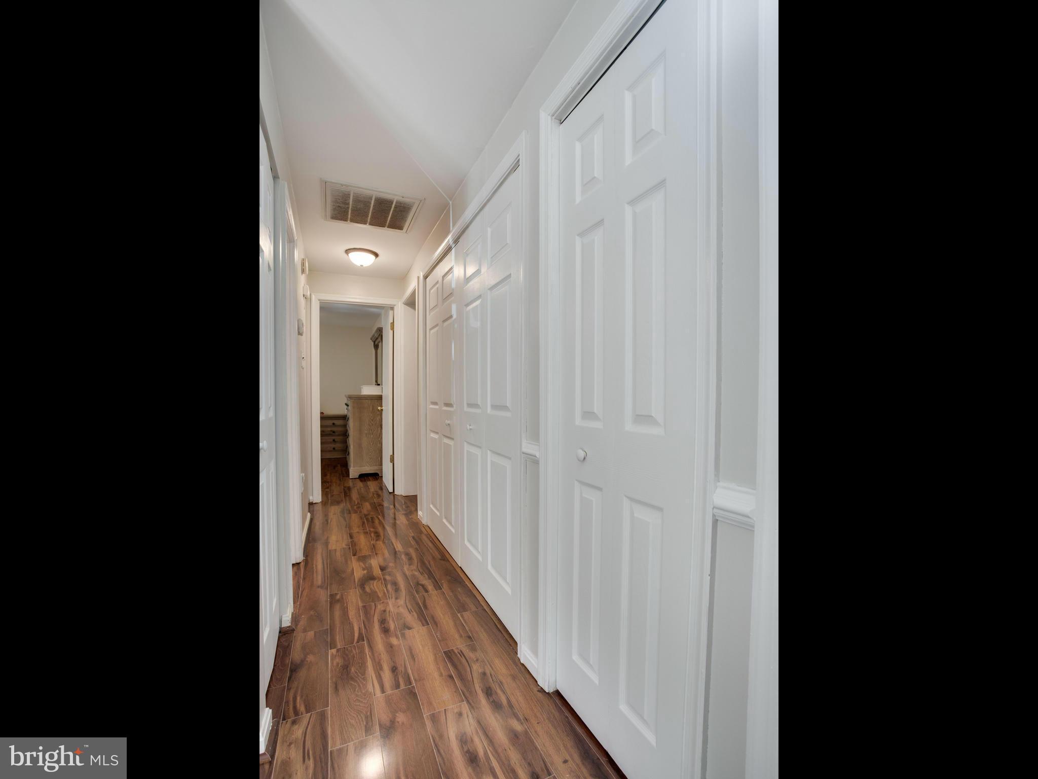 12708 Olivet Road Lusby, MD 20657 - Photo 14 of 22 a view of a hallway with wooden floor