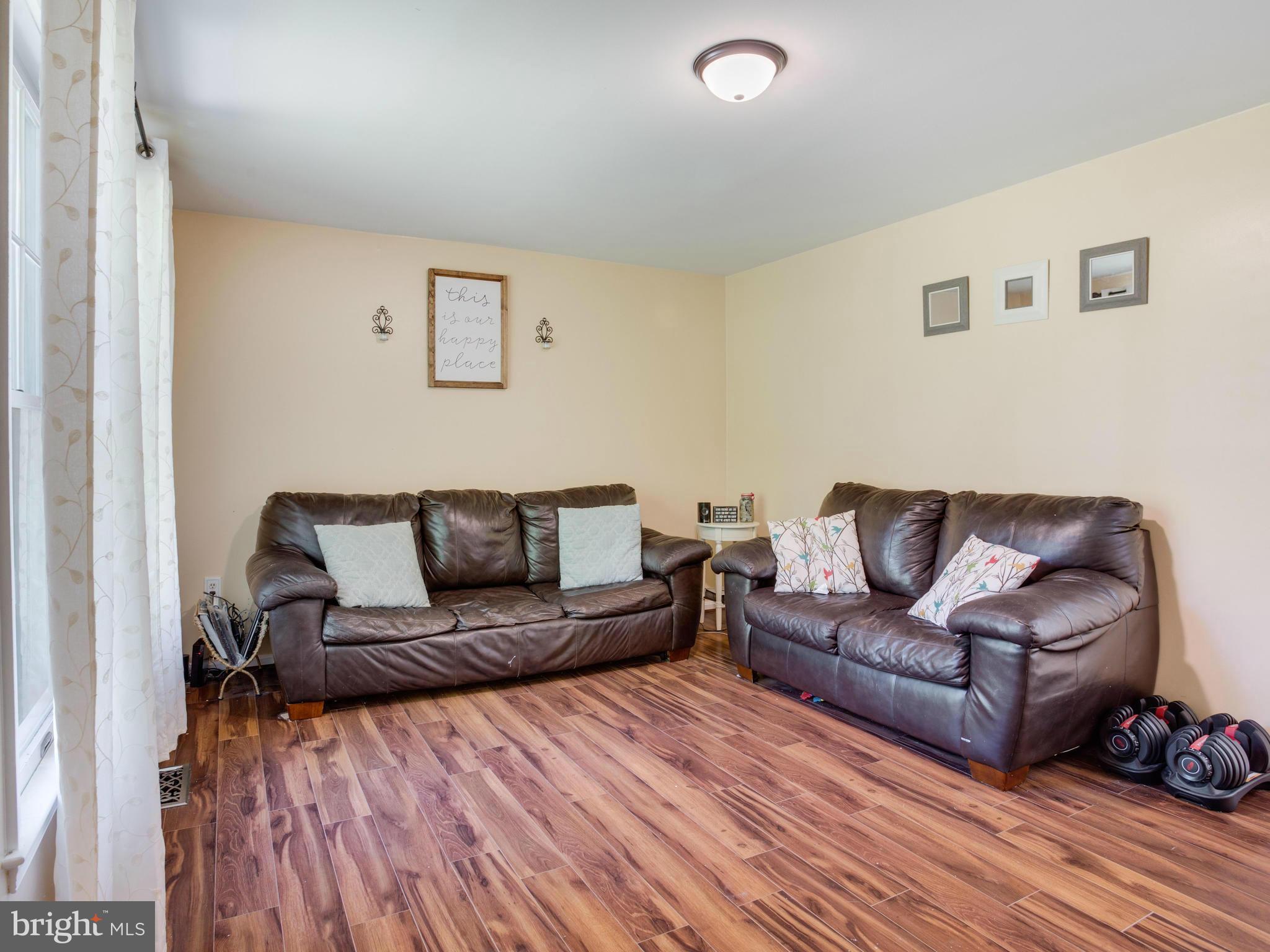 12708 Olivet Road Lusby, MD 20657 - Photo 16 of 22 a living room with furniture and a wooden floor