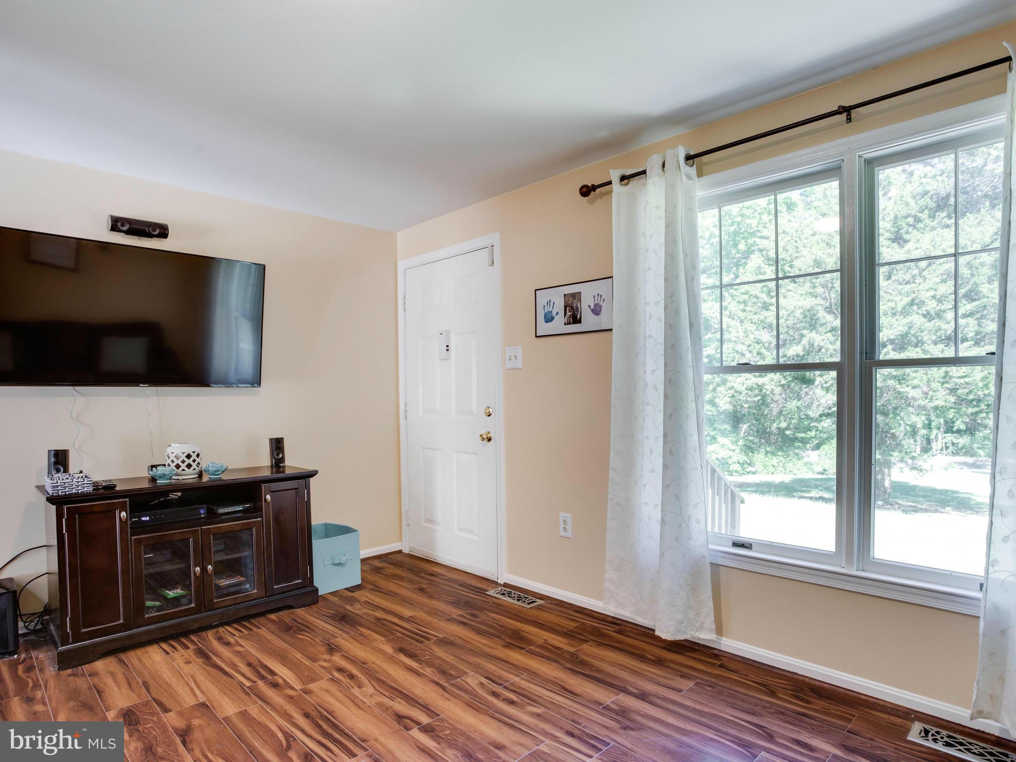 12708 Olivet Road Lusby, MD 20657 - Photo 18 of 22 a view of a livingroom with a flat screen tv and a window