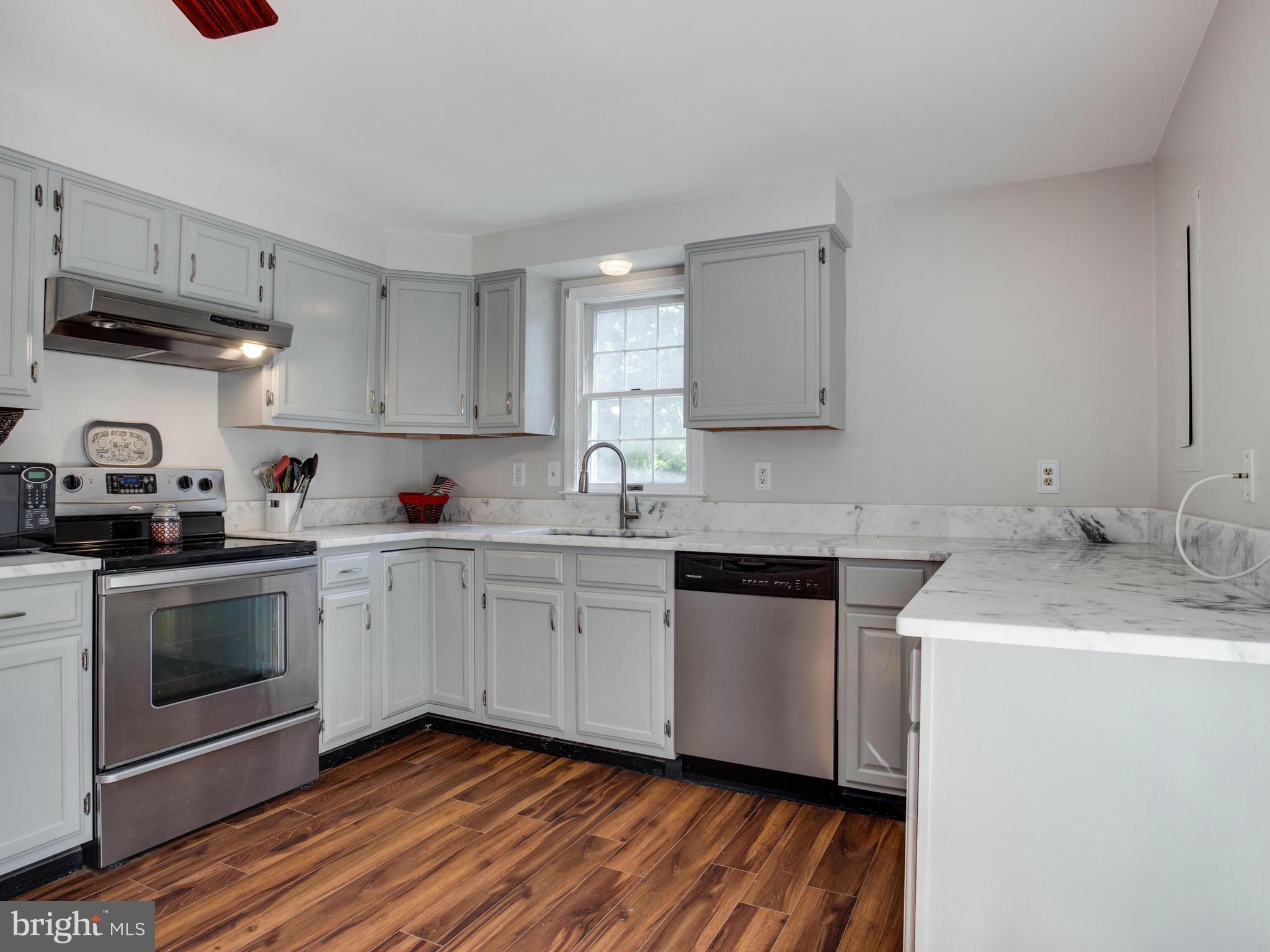 12708 Olivet Road Lusby, MD 20657 - Photo 3 of 22 a kitchen with granite countertop a sink stainless steel appliances and cabinets