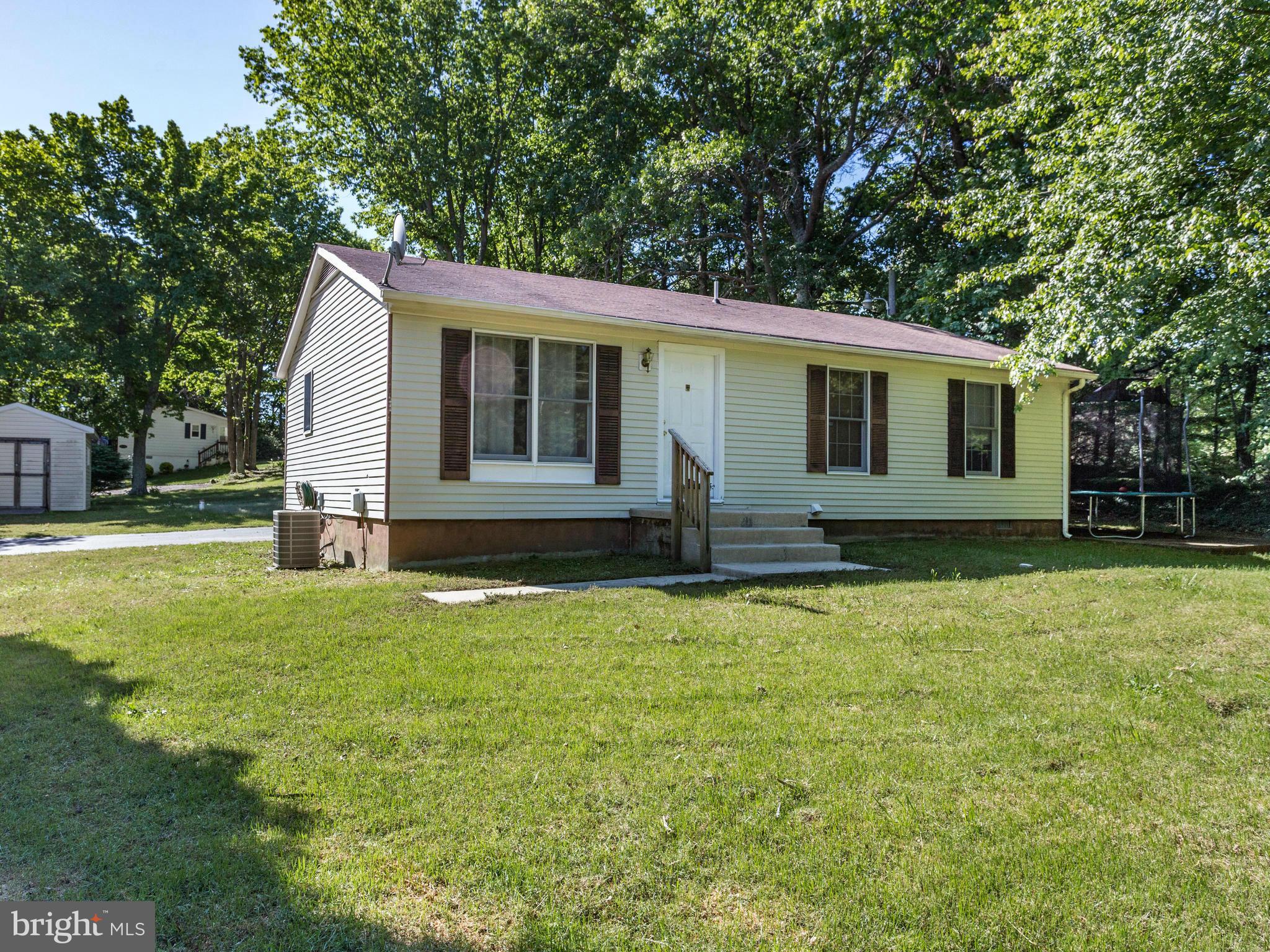 12708 Olivet Road Lusby, MD 20657 - Photo 21 of 22 a front view of house with yard and trees