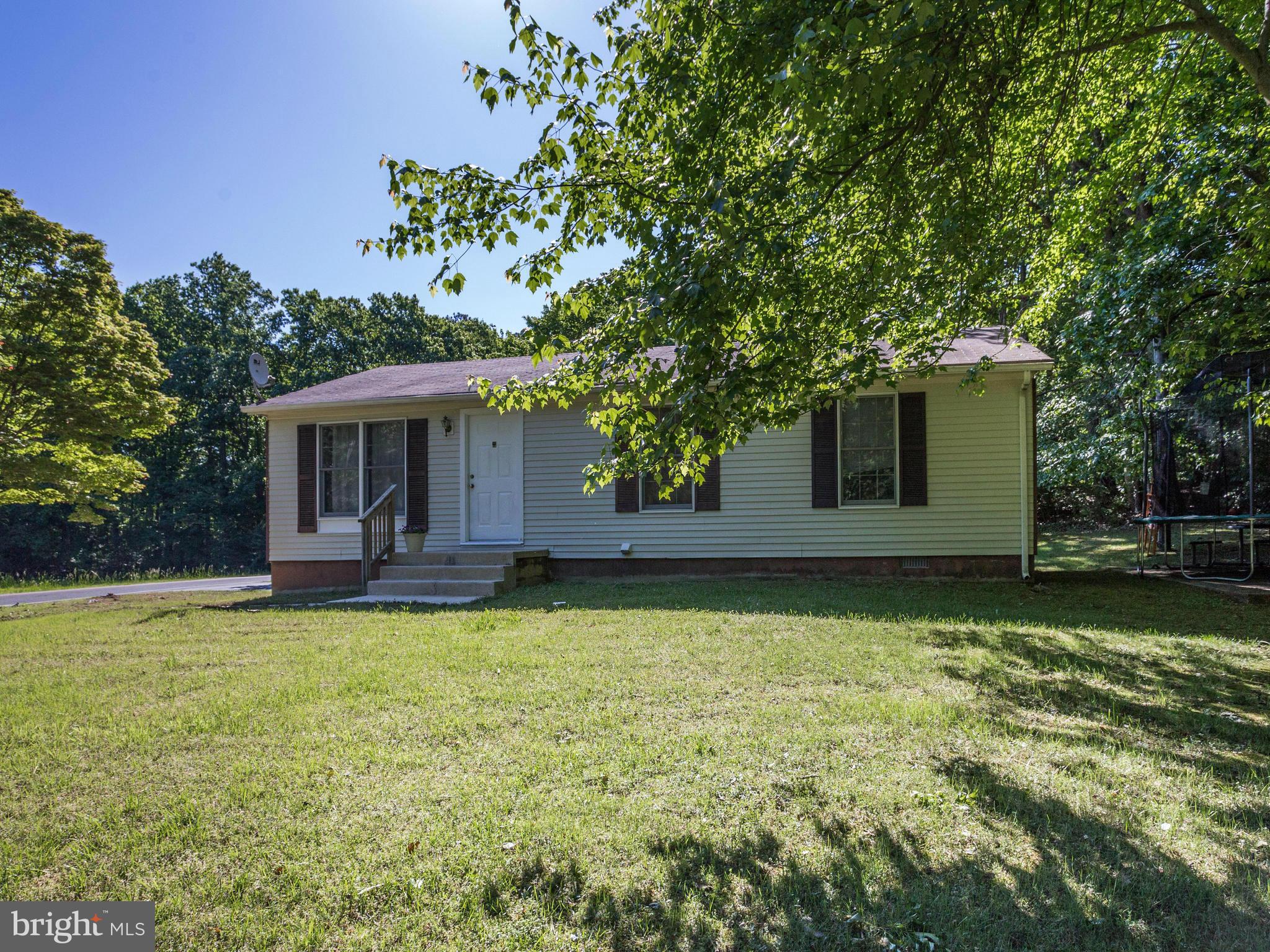 12708 Olivet Road Lusby, MD 20657 - Photo 22 of 22 a backyard of a house with table and chairs