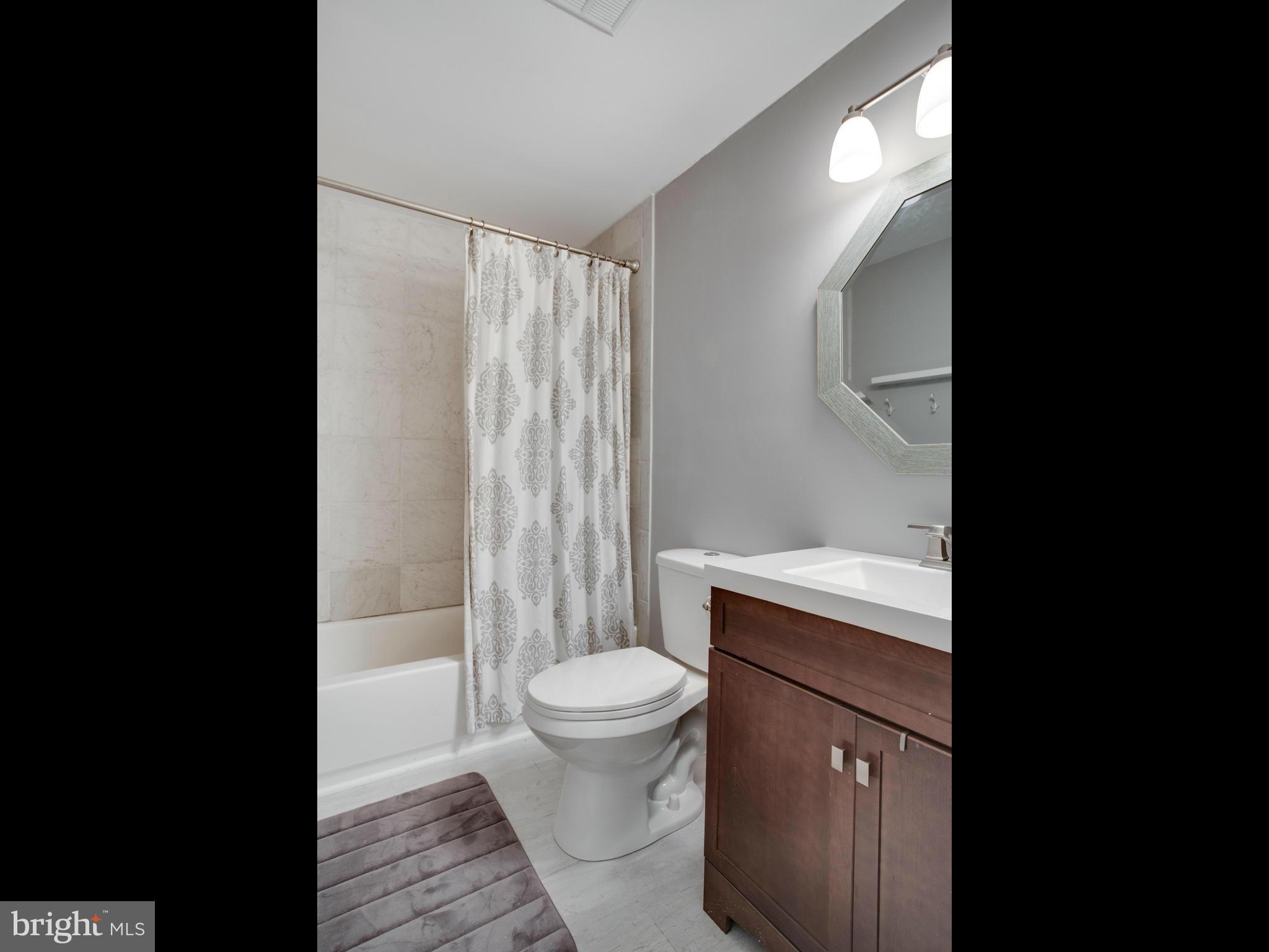 12708 Olivet Road Lusby, MD 20657 - Photo 6 of 22 a bathroom with a sink toilet and shower