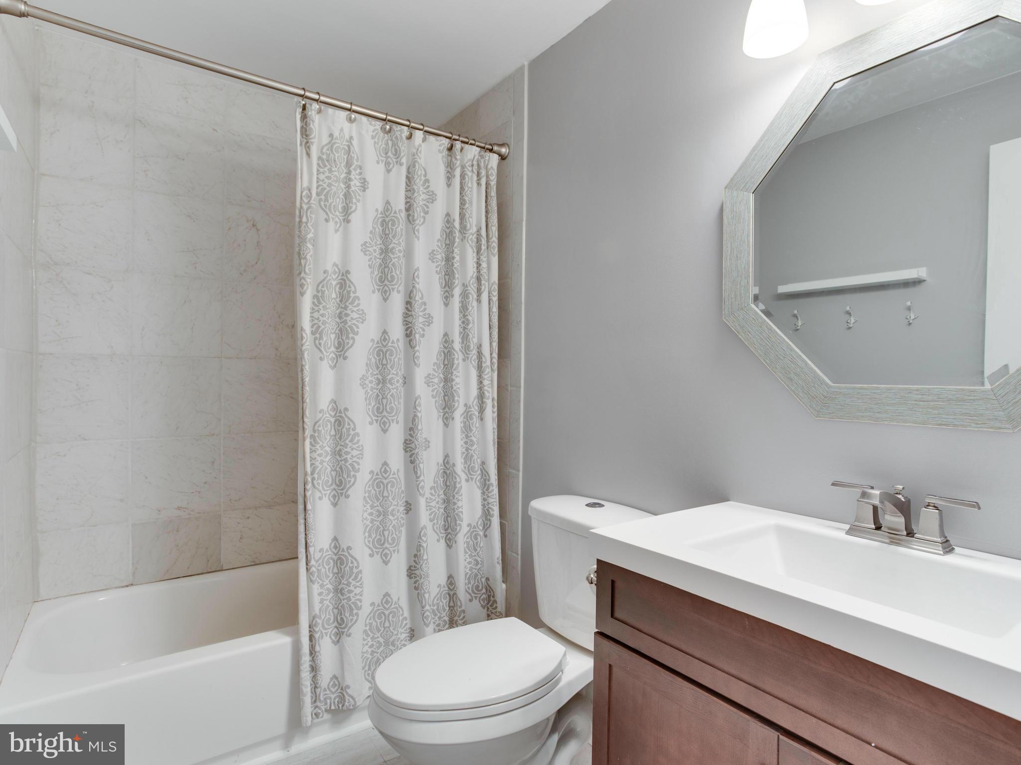 12708 Olivet Road Lusby, MD 20657 - Photo 7 of 22 a bathroom with a sink a toilet and shower