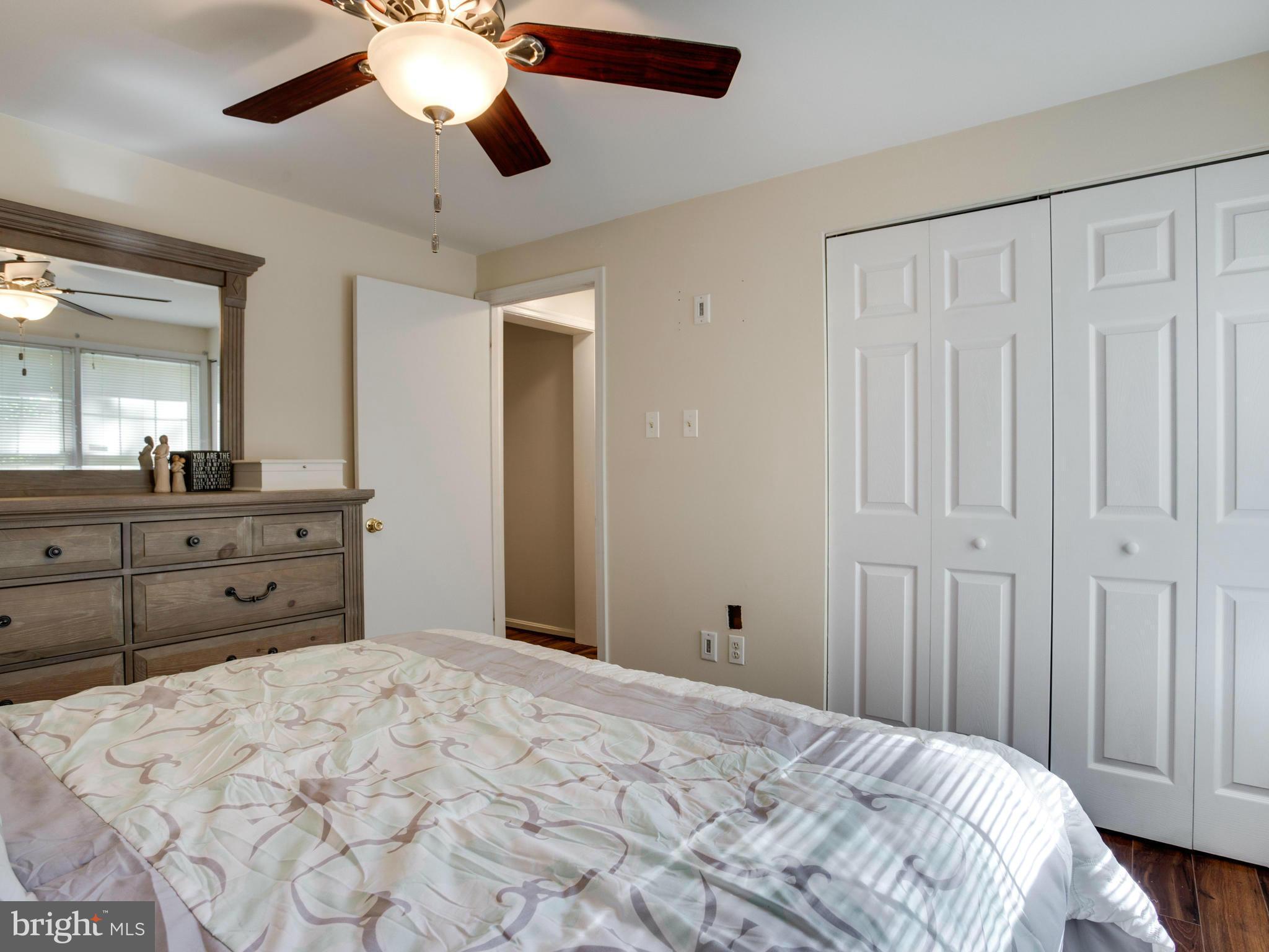 12708 Olivet Road Lusby, MD 20657 - Photo 9 of 22 a bed room with a large bed and a mirror