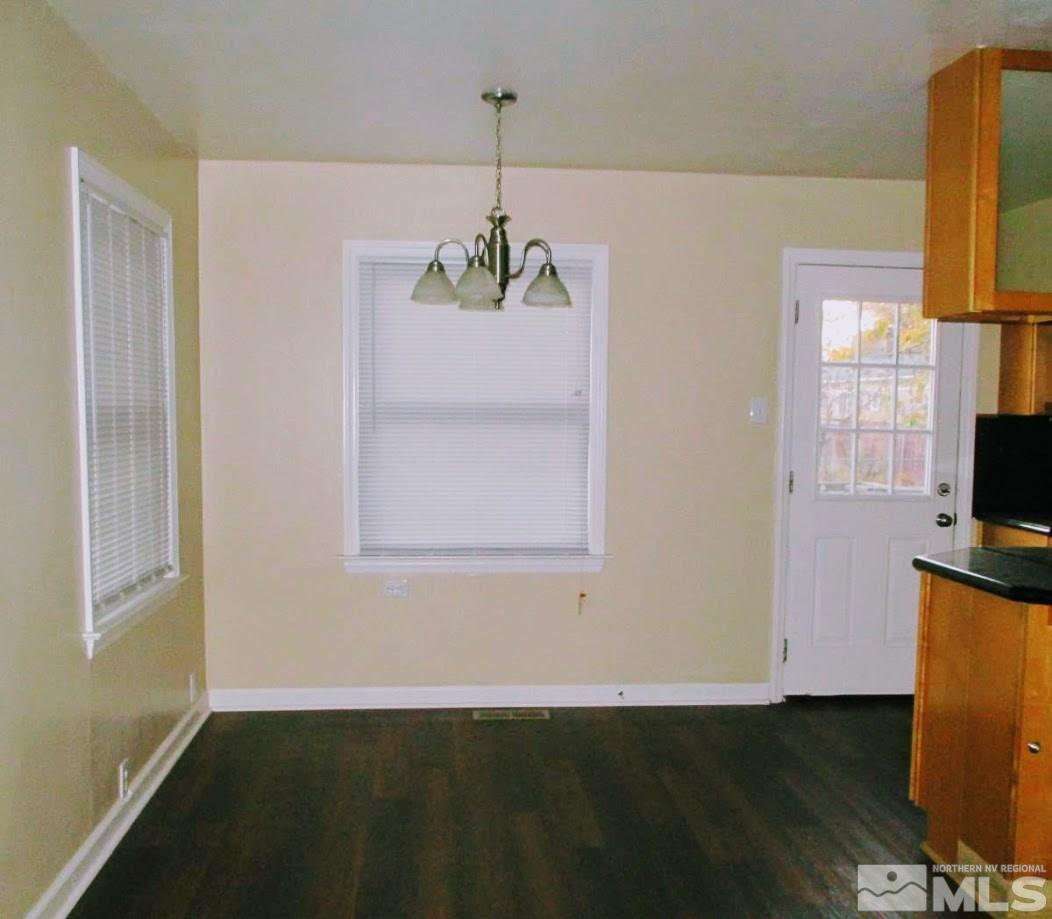 983 Lester Avenue Reno, NV 89502 - Photo 4 of 7 a view of an empty room with wooden floor and a window