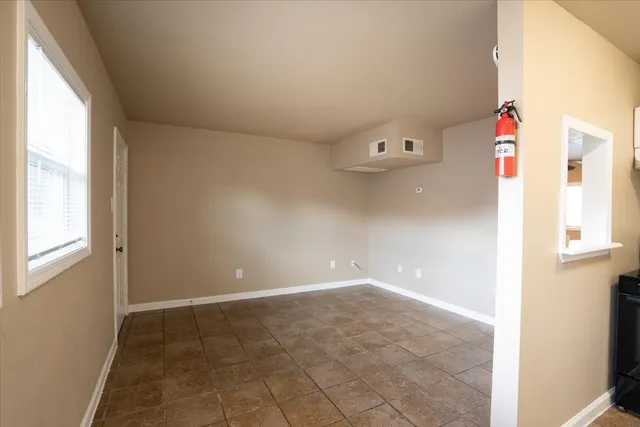 a view of an empty room with a window