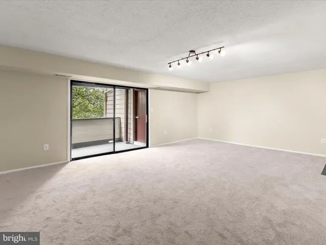 a view of an empty room with a fireplace