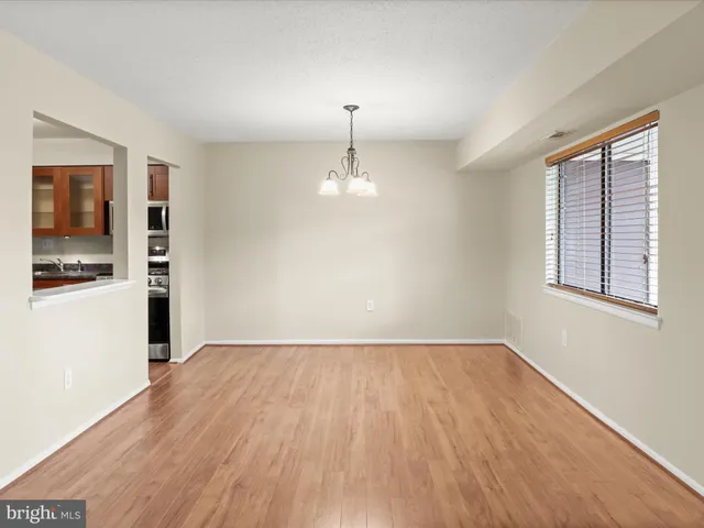 a big room with windows and chandelier