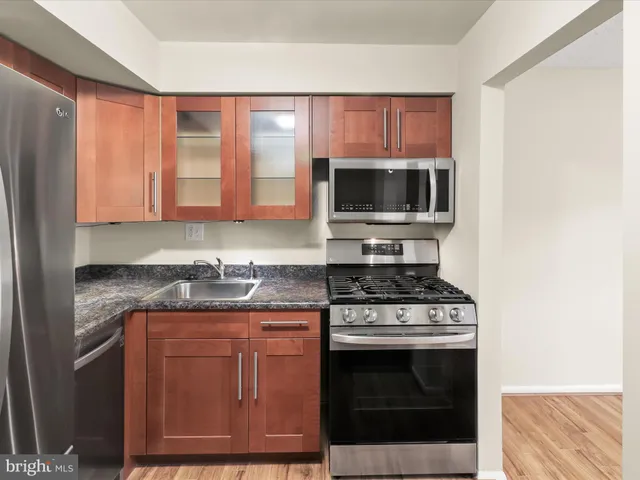 a view of kitchen island with wooden floor and sink