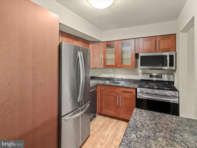 a kitchen with granite countertop a stove and a sink