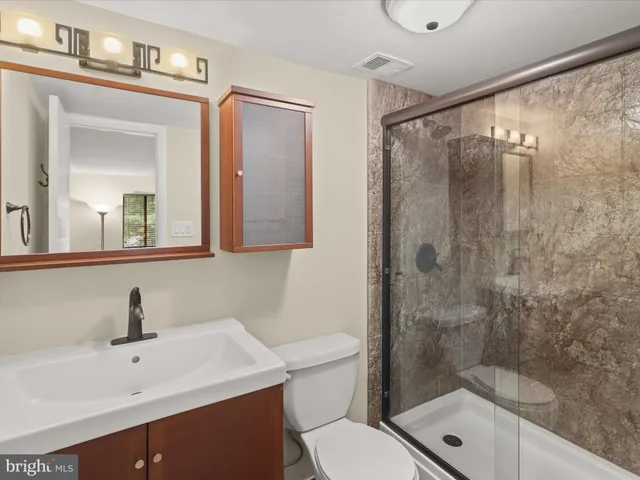 a bathroom with a sink mirror toilet and shower