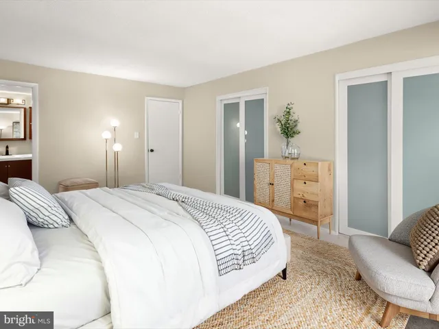 a bedroom with a bed table and chair