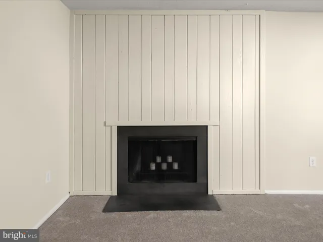 a living room with a fireplace and a fireplace