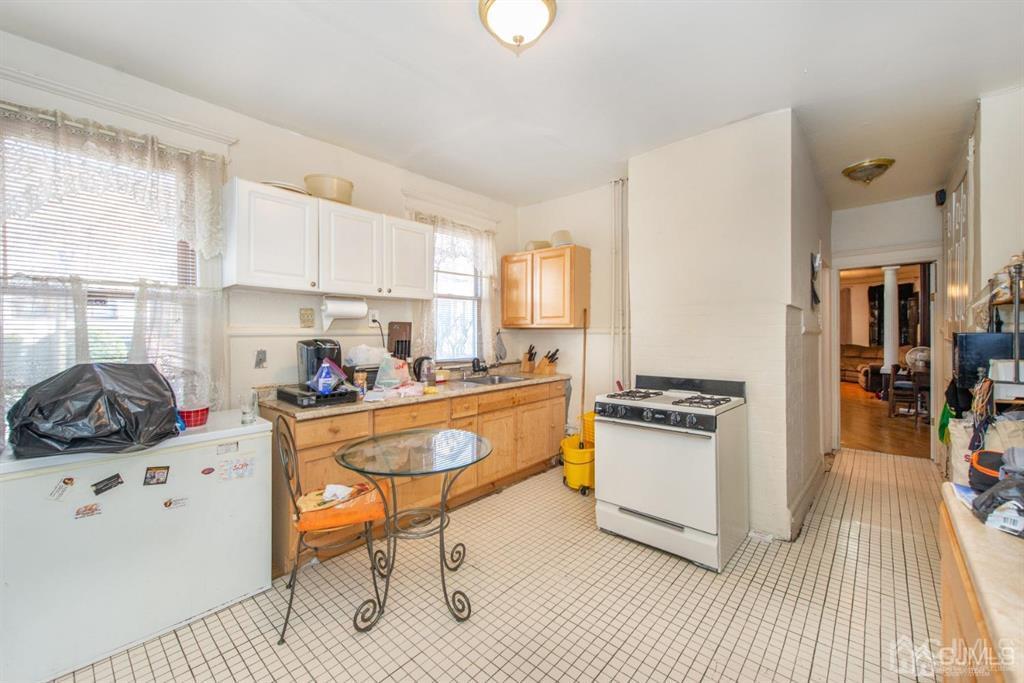 3 Ricord Street Newark, NJ 07106 - Photo 12 of 24 a kitchen with stainless steel appliances a stove a sink and a refrigerator