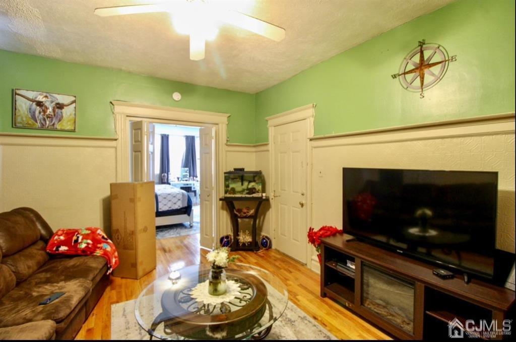3 Ricord Street Newark, NJ 07106 - Photo 13 of 24 a living room with furniture a flat screen tv and a fireplace