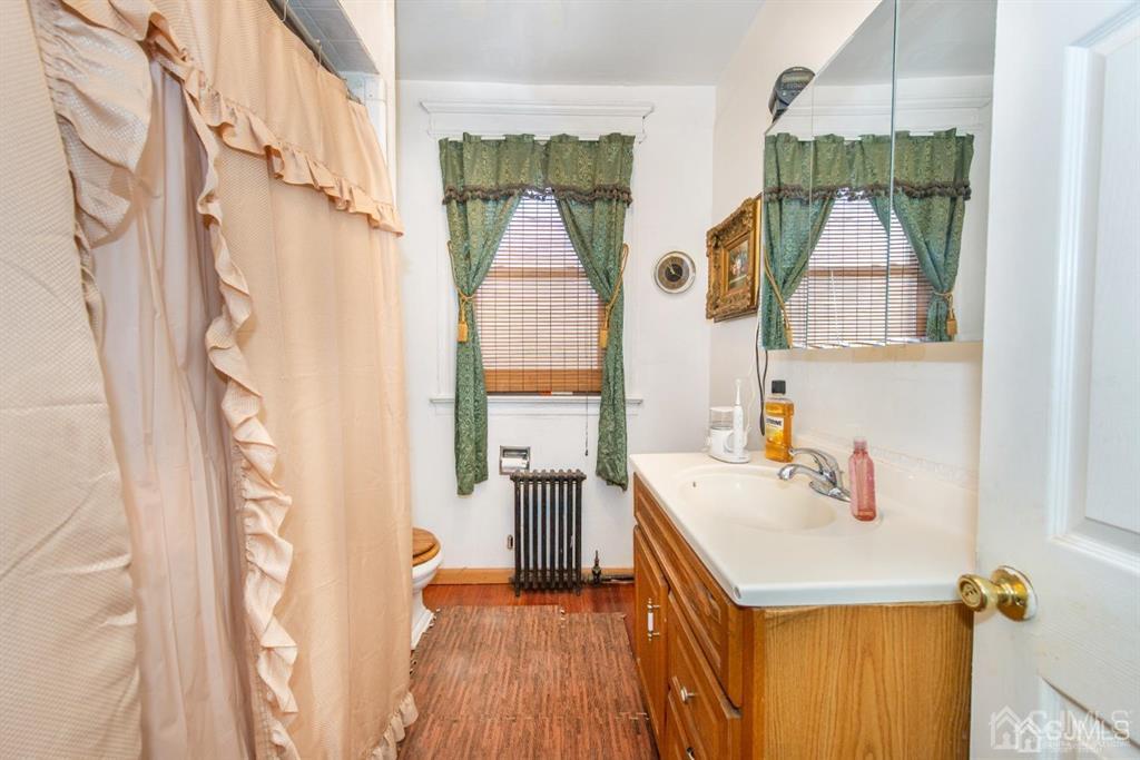 3 Ricord Street Newark, NJ 07106 - Photo 10 of 24 a bathroom with a sink a mirror and a shower