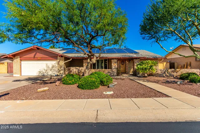 a blue swimming pool with outdoor seating and yard