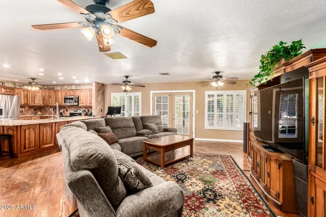 a living room with furniture and a chandelier