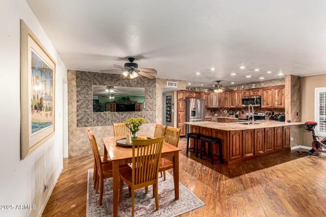 a kitchen with stainless steel appliances granite countertop a sink stove and cabinets