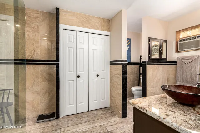 a bedroom with a bed couch and a window