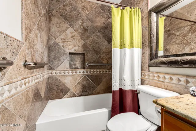 a view of a patio with chairs and wooden fence