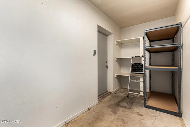 a view of a patio with table and chairs near a large tree