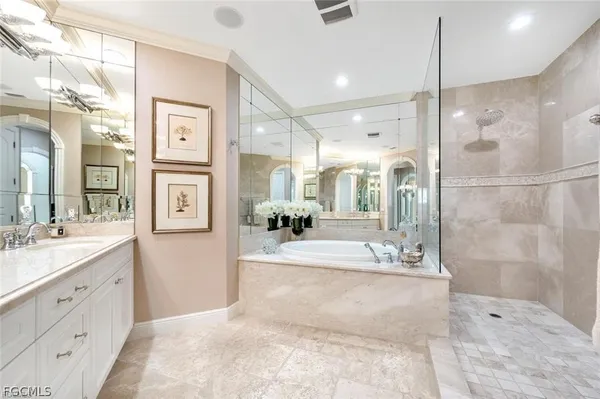 a spacious bathroom with a double vanity sink mirror and a shower