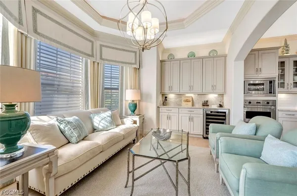 a living room with furniture and kitchen view