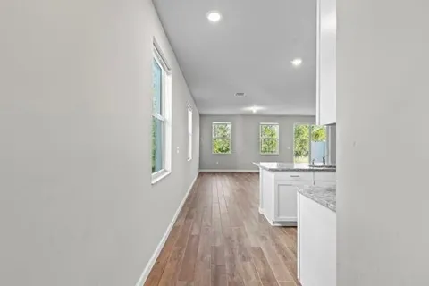 a kitchen with kitchen island granite countertop appliances cabinets and a sink