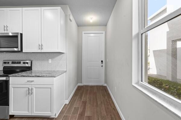 238 Osprey Preserve Boulevard Stuart, FL 34994 - Photo 5 of 31 a stove top oven sitting inside of a kitchen