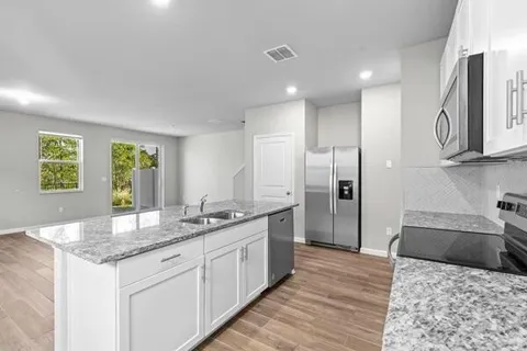 a kitchen with a sink and cabinets
