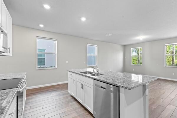 238 Osprey Preserve Boulevard Stuart, FL 34994 - Photo 9 of 31 a kitchen with a sink and cabinets
