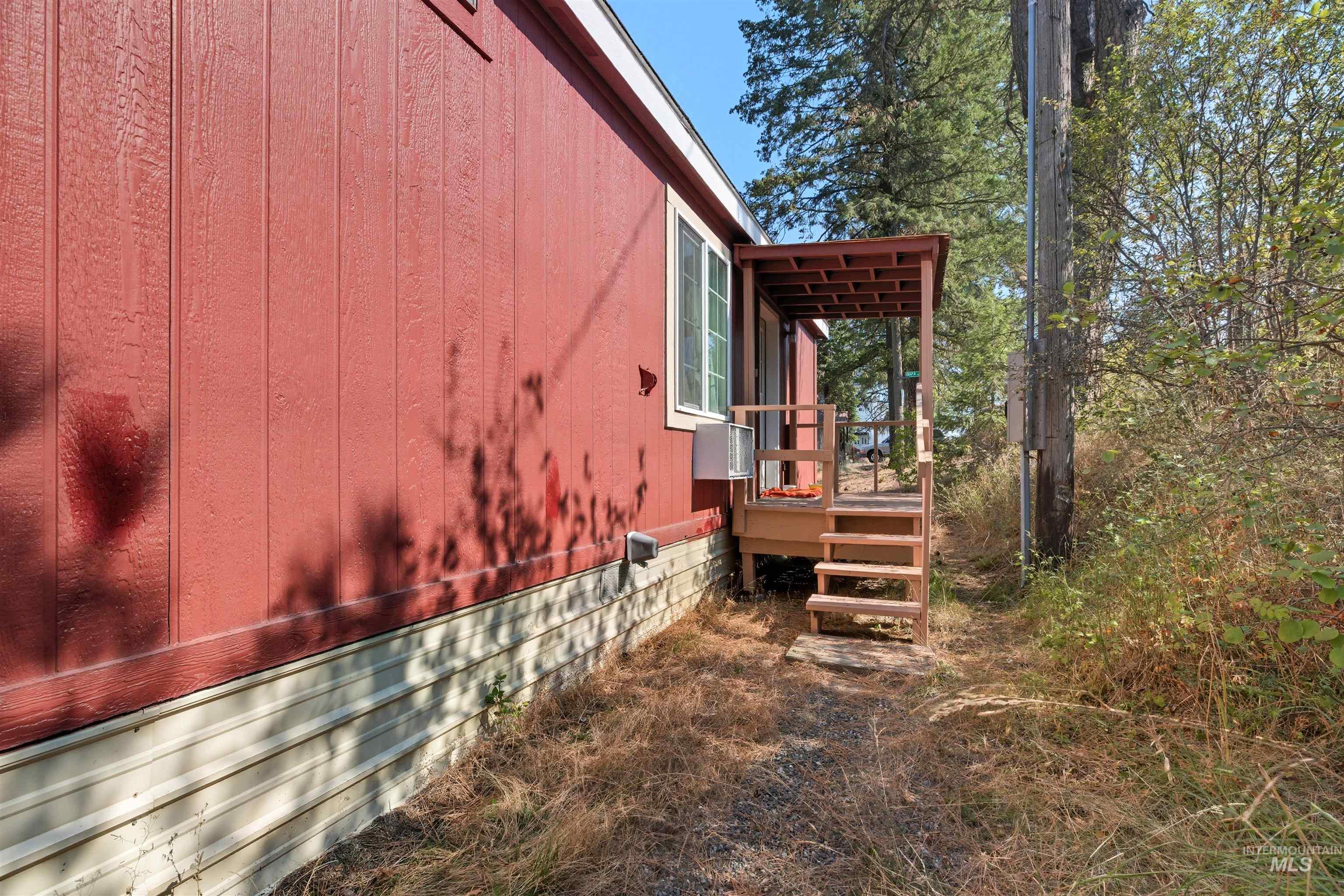 300 Main Street Deary, ID 83823 - Photo 18 of 18 View of property exterior featuring a deck, crawl space, and cooling unit