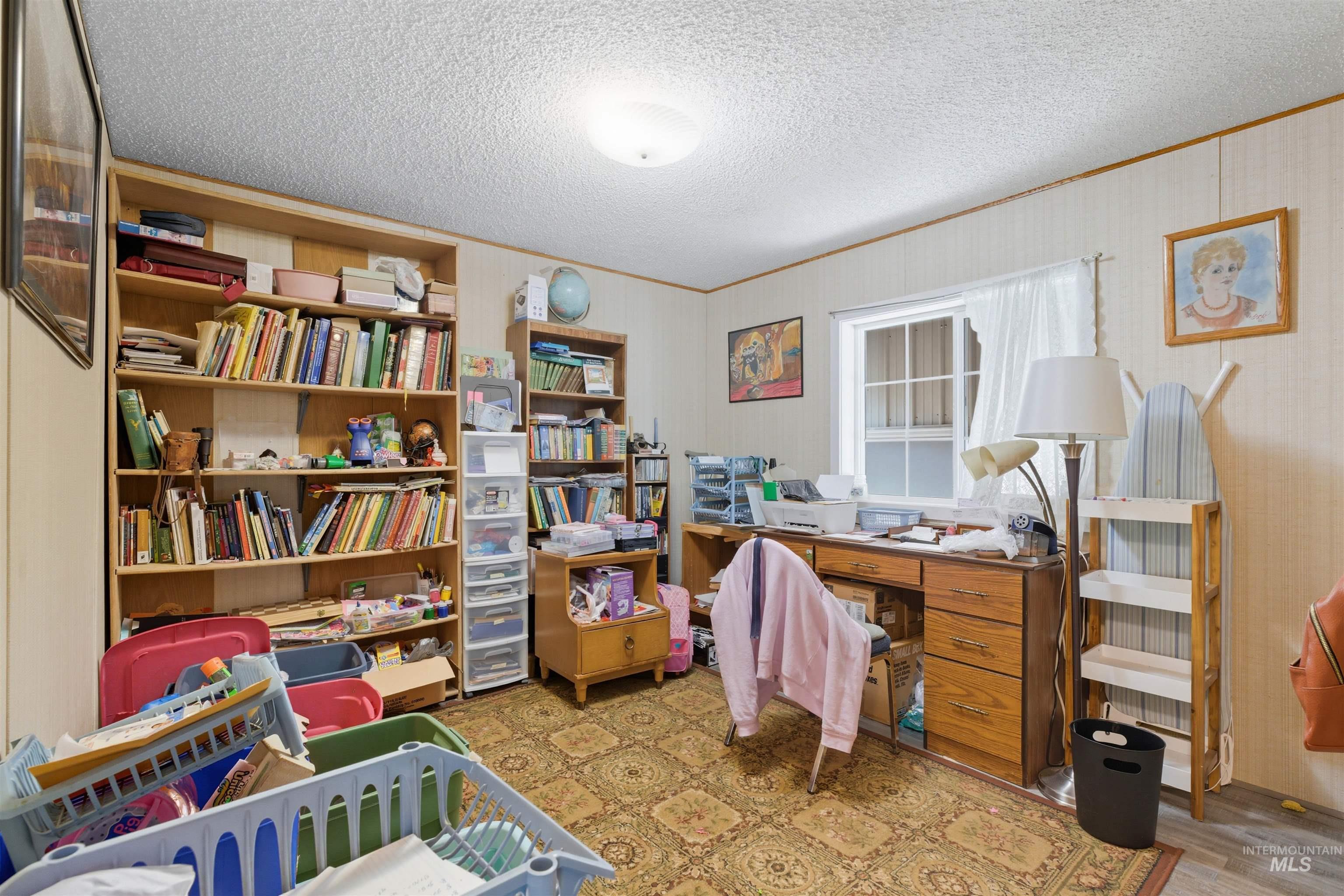 300 Main Street Deary, ID 83823 - Photo 10 of 18 Home office with a textured ceiling, light wood-type flooring, and ornamental molding