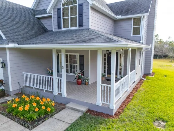 a view of a house with a porch and wooden floor