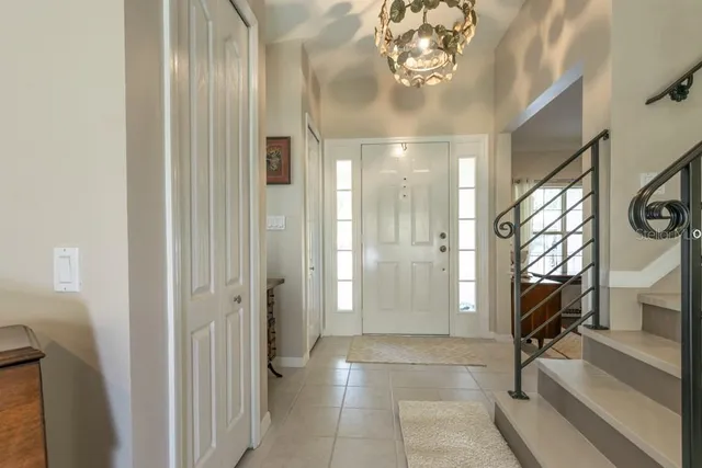 a view of a hallway with wooden floor and a bathroom