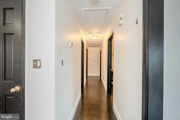 a view of a hallway with wooden floor