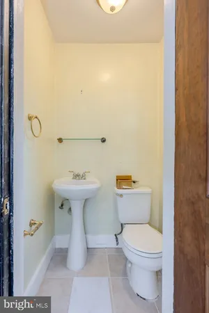 a bathroom with a sink a toilet and mirror