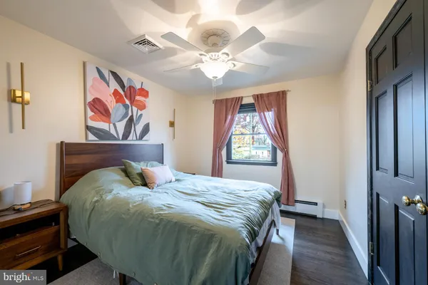 a bed sitting in a bedroom next to a window
