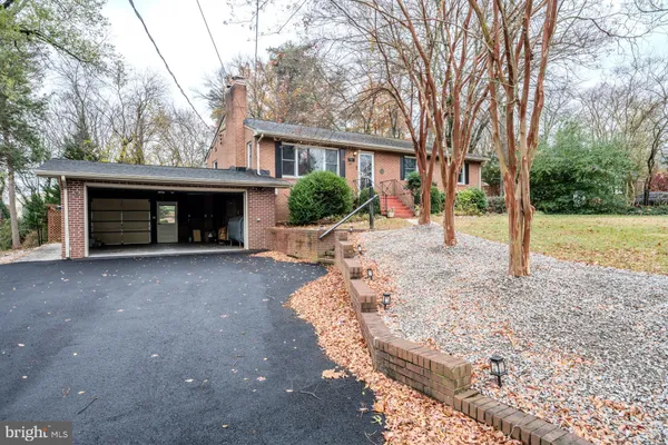 a view of a house with a yard and garage