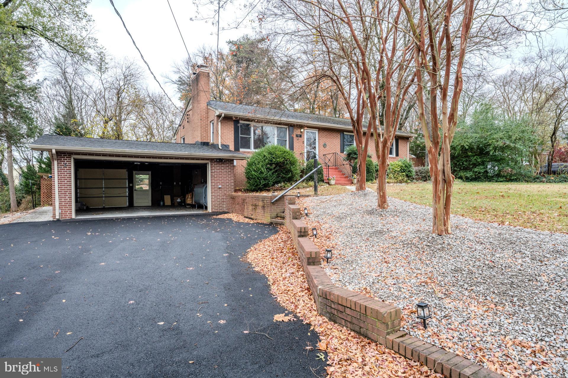 1329 Devils Reach Road Woodbridge, VA 22192 - Photo 2 of 33 a view of a house with a yard and garage
