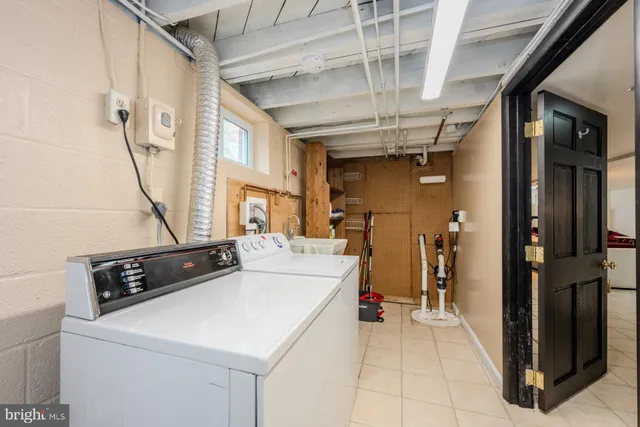 a front view of a house with a yard covered with snow