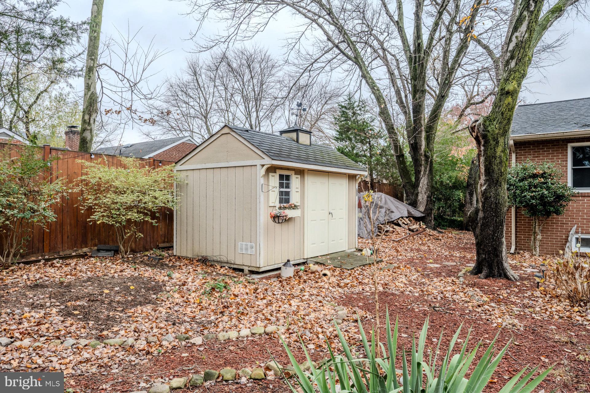 1329 Devils Reach Road Woodbridge, VA 22192 - Photo 30 of 33 a view of a wooden house with a yard and large trees