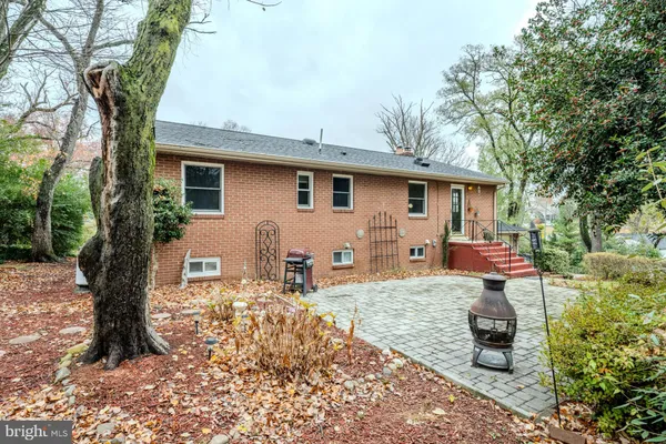 a front view of a house with a yard covered with snow