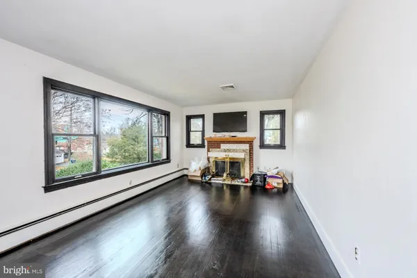 a living room with furniture and a flat screen tv with wooden floor