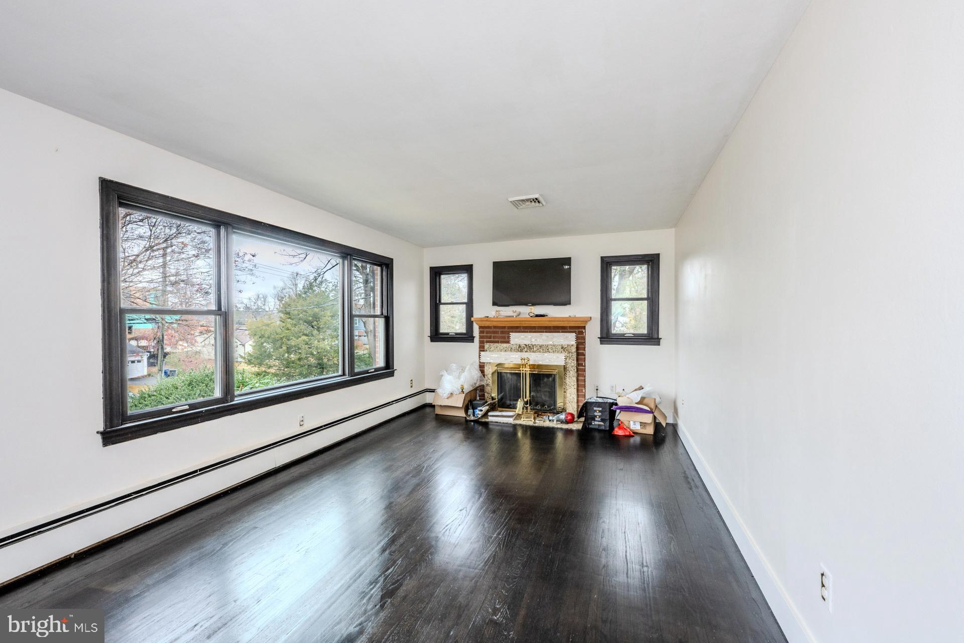 1329 Devils Reach Road Woodbridge, VA 22192 - Photo 6 of 34 a living room with furniture and a flat screen tv with wooden floor