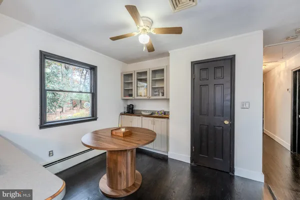 a room with table chairs and wooden floor