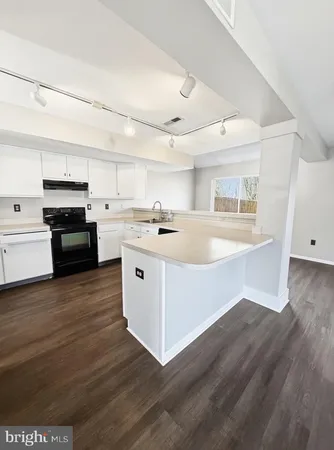 a kitchen with stainless steel appliances granite countertop a stove and a refrigerator